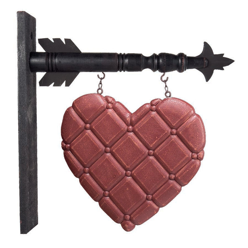 Decorative heart-shaped plaque with a black arrow on a white background