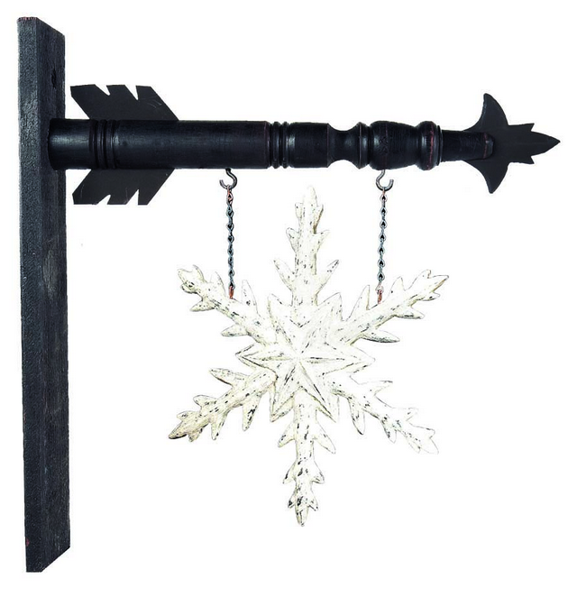 Decorative snowflake hanging from a black metal rod on a white background
