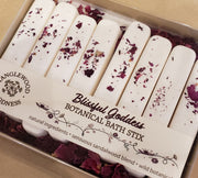 Box of Blissful Goddess Botanical Bath Stix with sandalwood blend and wild botanicals on a beige background.