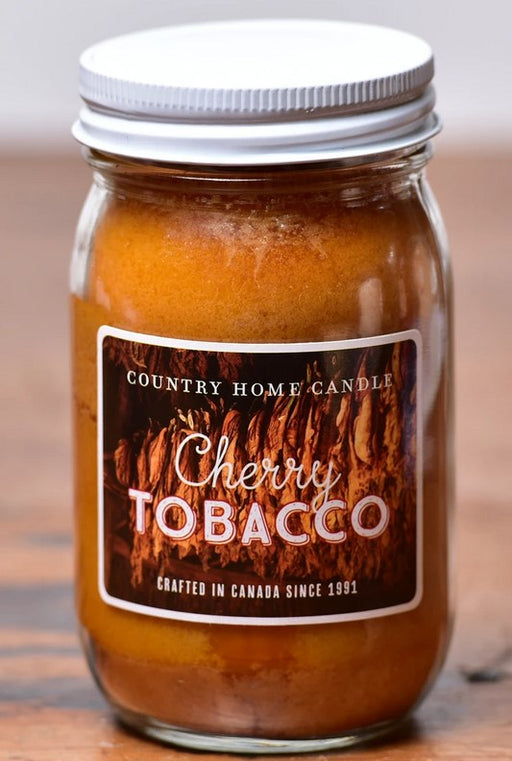 Jar of Country Home Candle Cherry Tobacco candle on a wooden surface