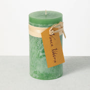 Green candle with a brown tag on a white background