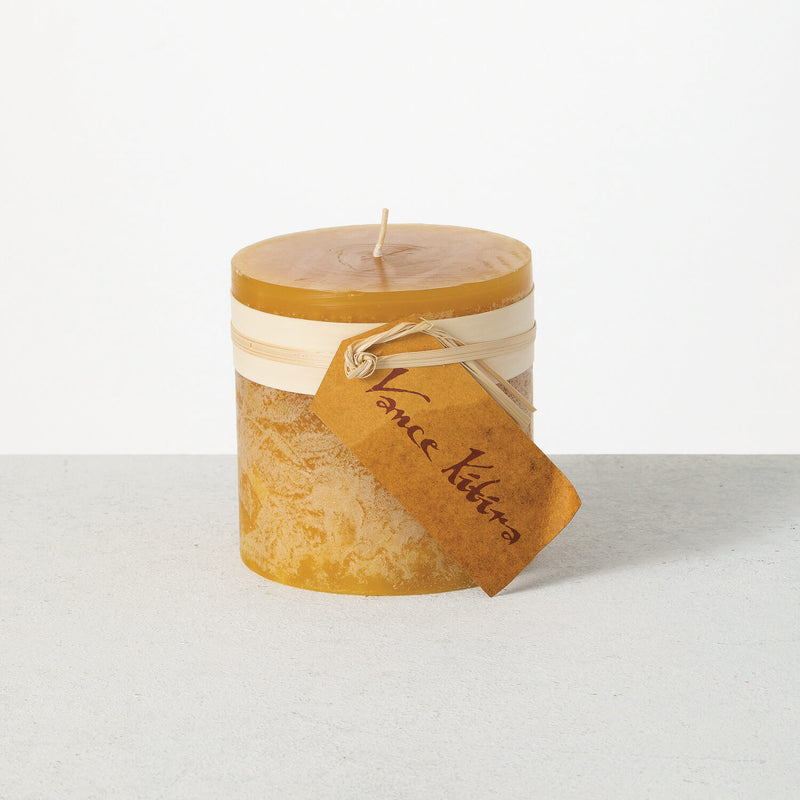 Candle with a decorative tag on a white background
