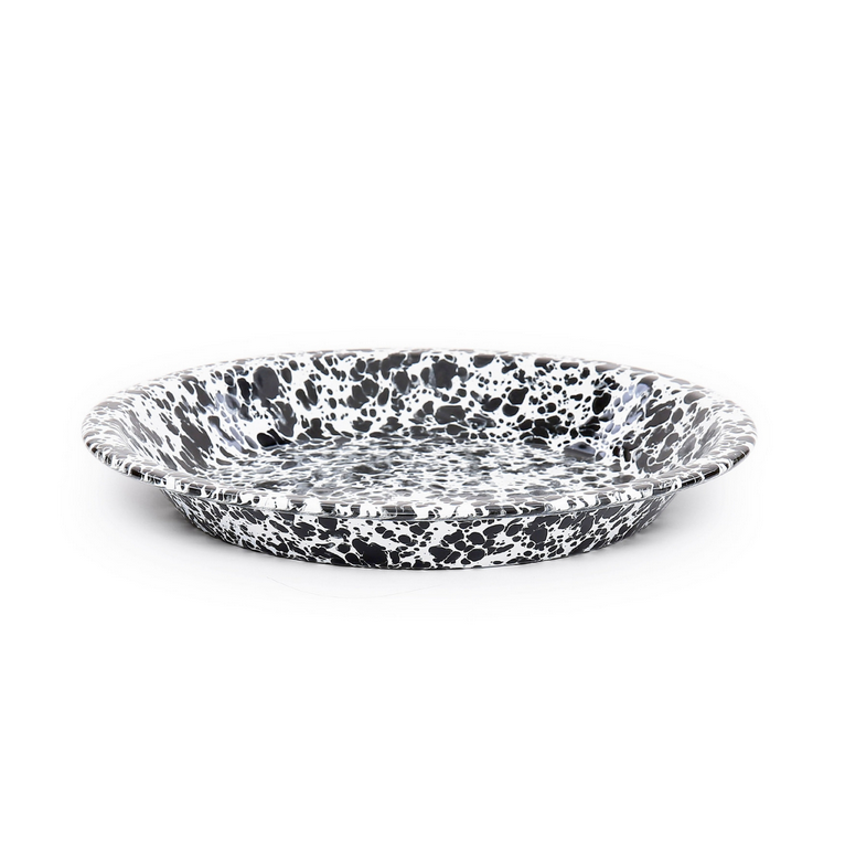 Speckled black and white ceramic plate on a white background