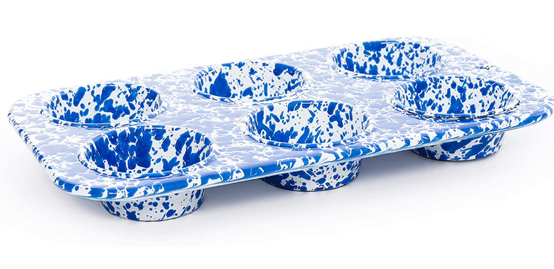 Blue and white speckled muffin tin on a white background