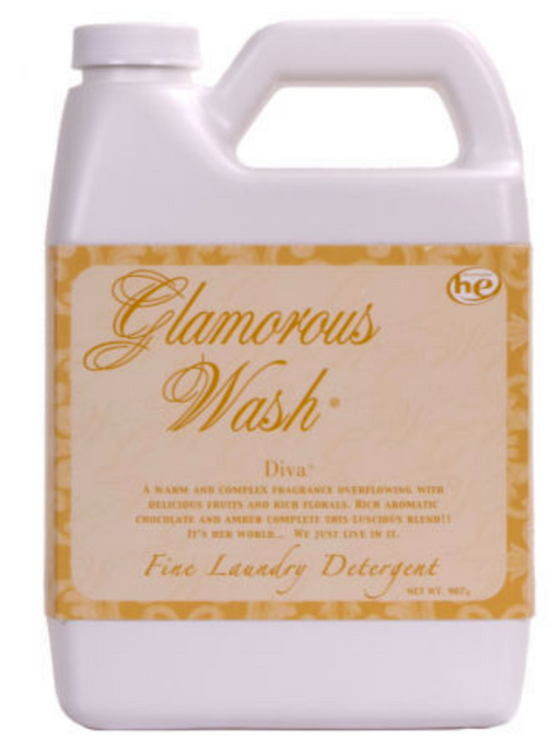 A plastic bottle of Tyler Glamorous Wash laundry detergent with a label that has a beige background and gold text, displaying the name 'Glamorous Wash' and 'Diva'.