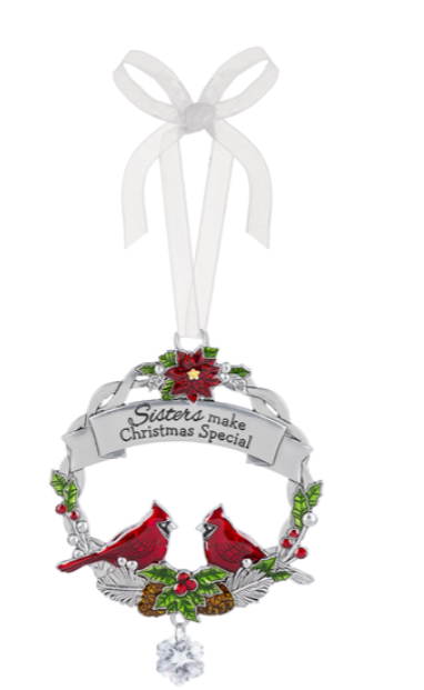 Christmas ornament with two red cardinals, holly, and a banner on a white background