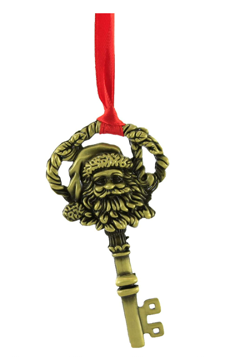 Decorative key ornament with Santa Claus face on a white background