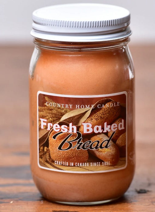 A jar candle with a label reading 'Fresh Baked Bread', indicating the scent of the candle.