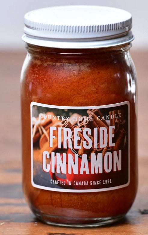 Jar of 'Fireside Cinnamon' candle with a label on a wooden surface