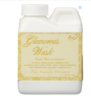 Glamorous Wash laundry detergent bottle with decorative label on a white background