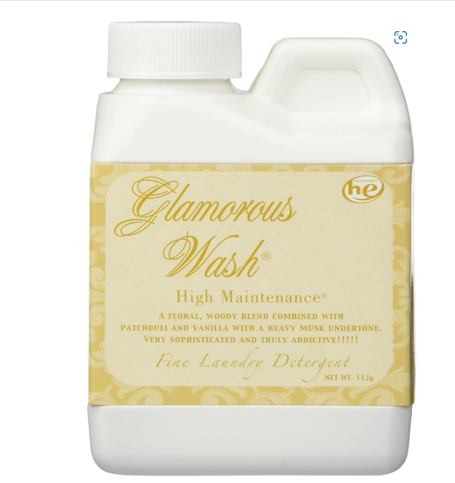 Glamorous Wash laundry detergent bottle with decorative label on a white background