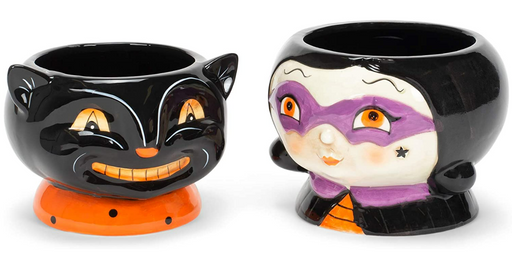Two Halloween-themed ceramic pots, one black cat and one witch, on a white background.