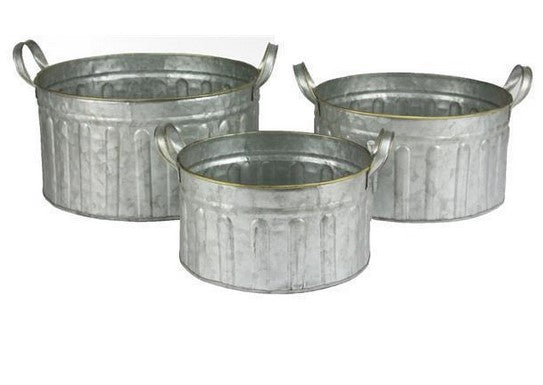 Three galvanized metal buckets of different sizes on a white background