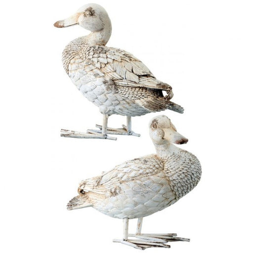 Two white duck decoys on a white background