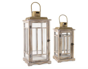 Two wooden lanterns with glass panels on a white background