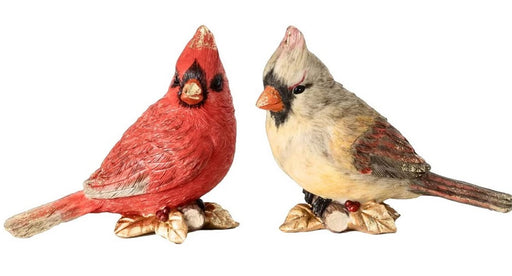Two bird figurines, one red and one multicolored, on a white background
