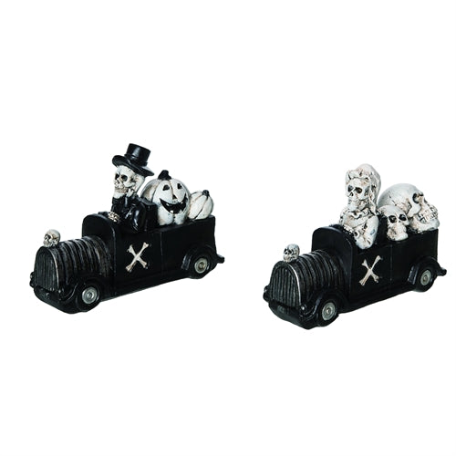 Two black toy trains with skull figures on a white background