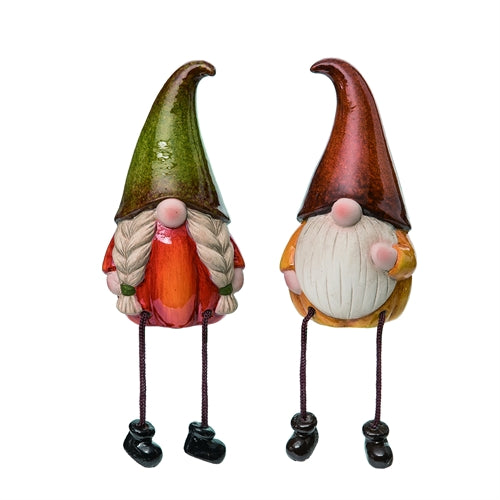 Two colorful gnome figurines with green and red hats on a white background