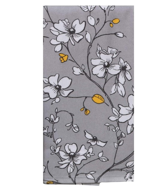 Floral patterned fabric with white flowers and yellow leaves on a gray background