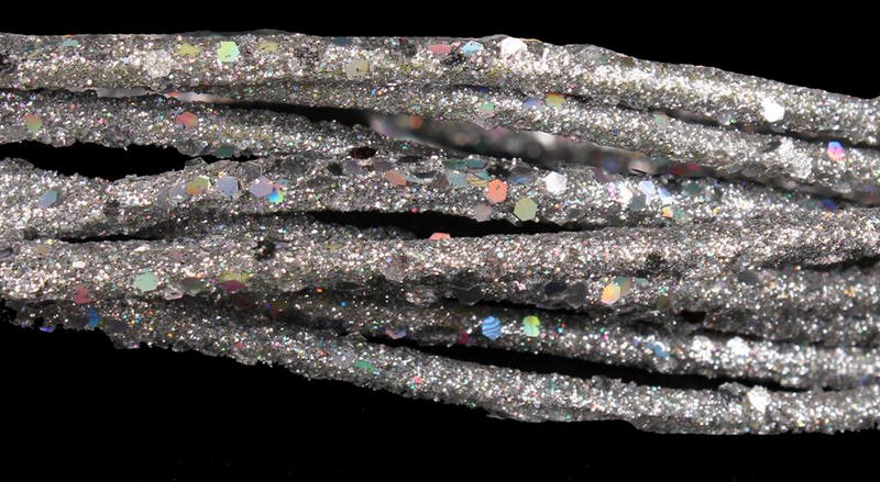 Silver glittery cord on a black background