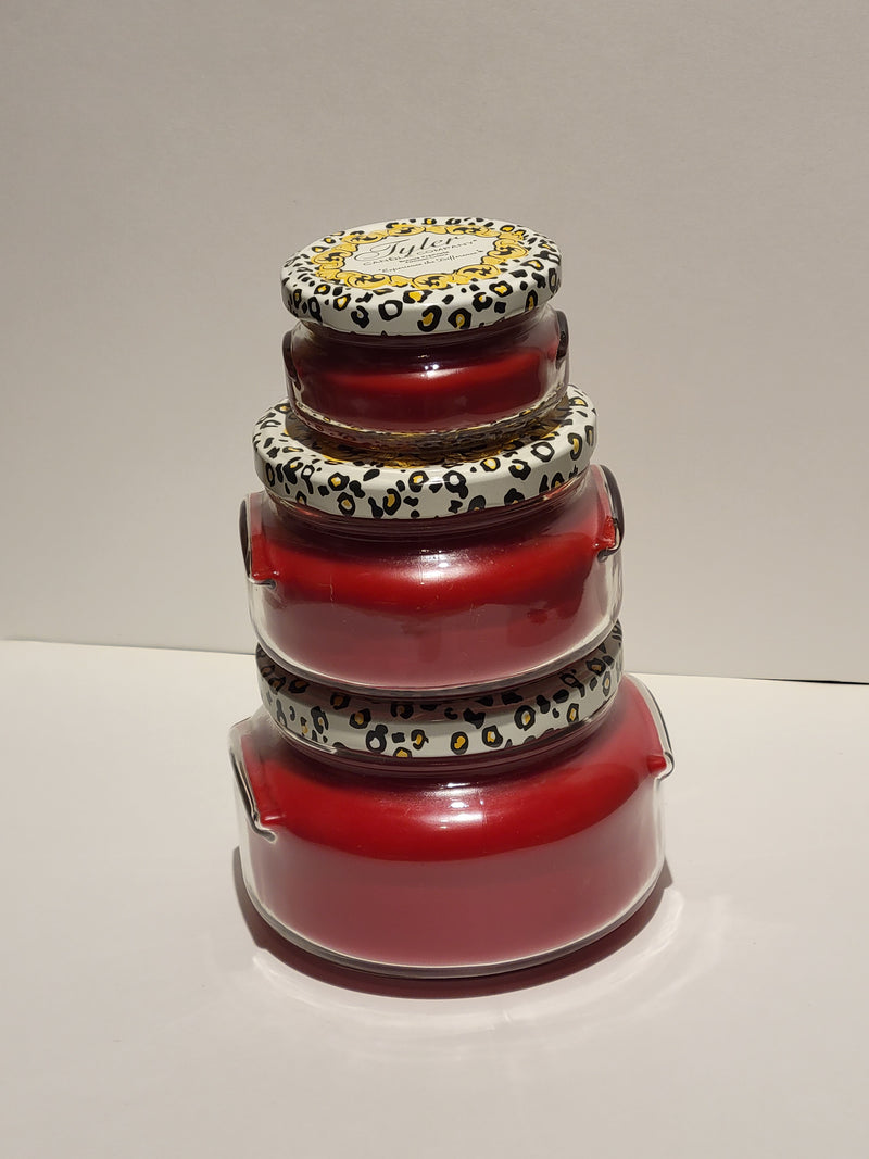 Stack of red candles with leopard print patterns on a white background