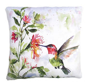 A decorative pillow with a watercolor painting of a hummingbird beside a plant with pink flowers.