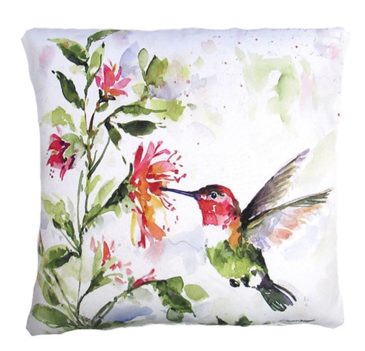 A decorative pillow with a watercolor painting of a hummingbird beside a plant with pink flowers.