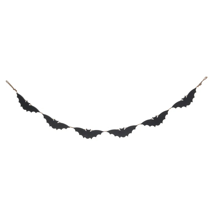Black bat-shaped decorative item on a white background