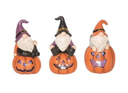 Three Halloween-themed gnomes with jack-o'-lanterns on a white background
