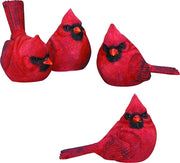 Four red cardinal bird figurines on a white background