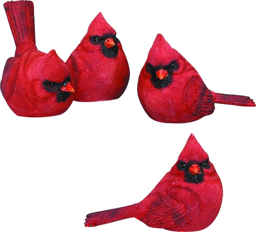 Four red cardinal bird figurines on a white background