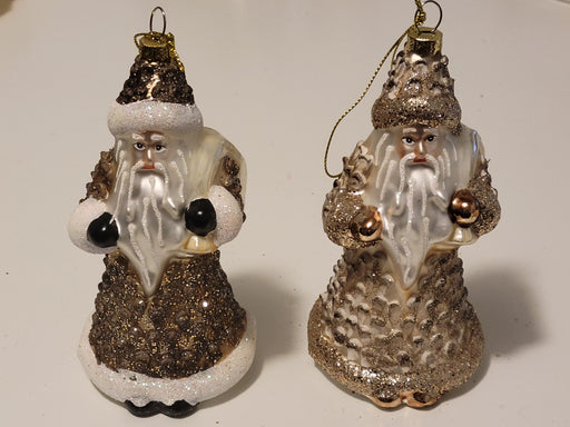 Two decorative Santa Claus ornaments with glittery textures on a white background